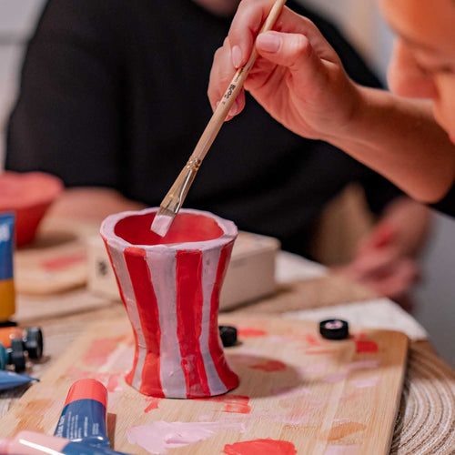 A woman's hand painting a clay piece created using the Double Date Night Bundle Pottery Bundle Sculpd