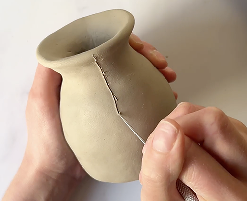 Sculpd Pinch Pot being hand-carved with a metal tool