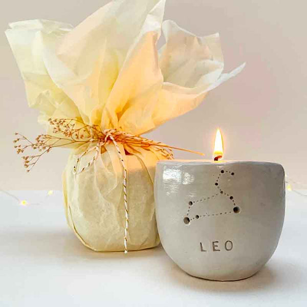A handmade clay candle holder with a 