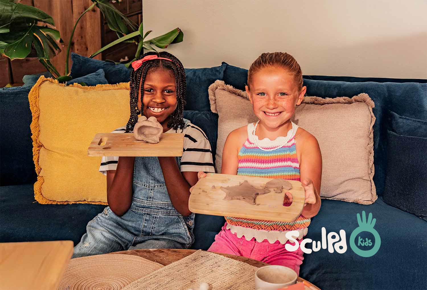 Two kids with their pottery creation